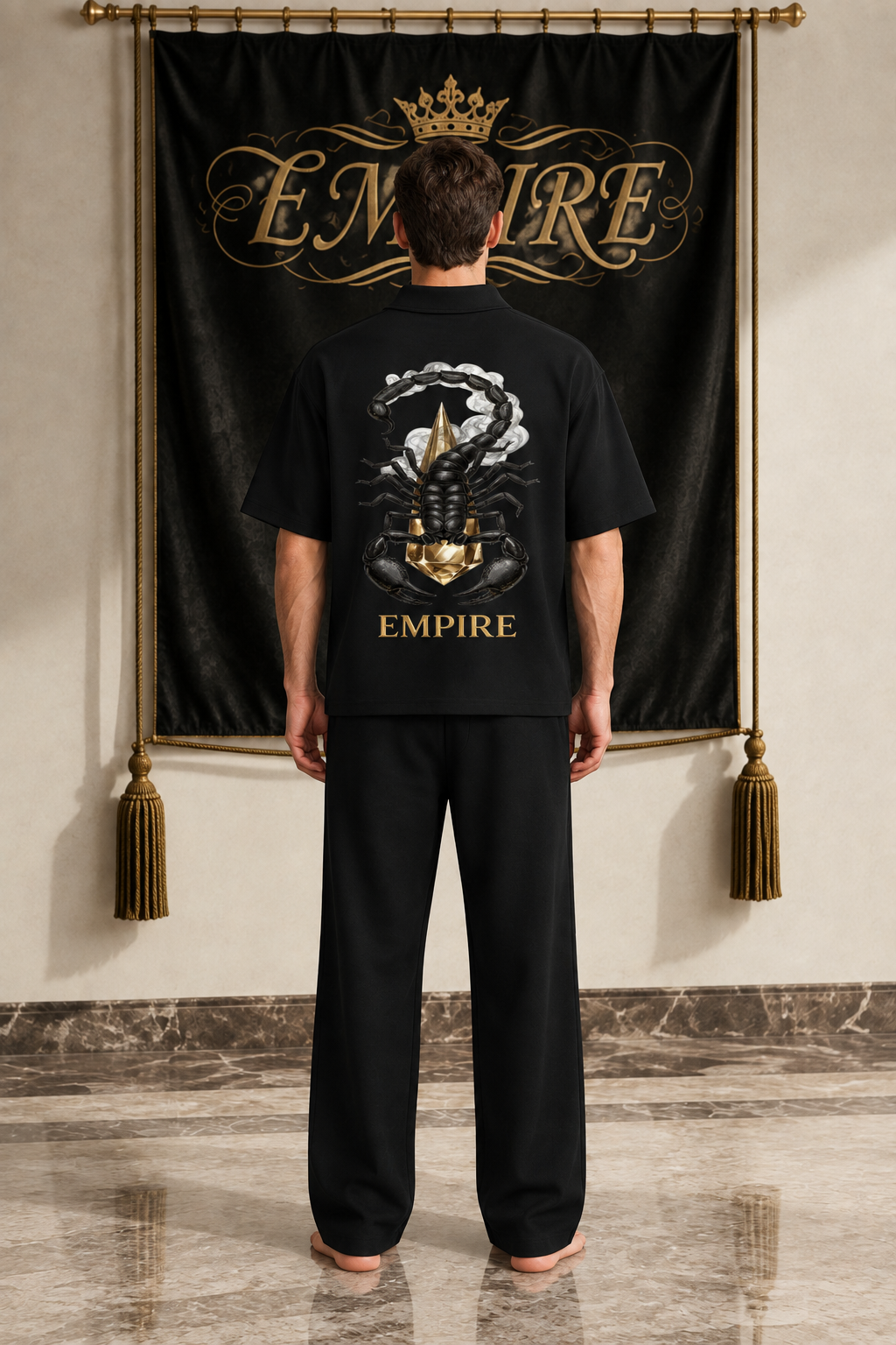 Black men's EMPIRE quarter-zip polo shirt with dimensional black scorpion, gold crystal and smoke back graphic, rear view on barefoot male model