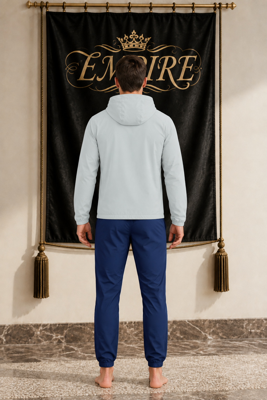 Light grey men's EMPIRE hooded sports jacket with plain back, rear view on barefoot male model