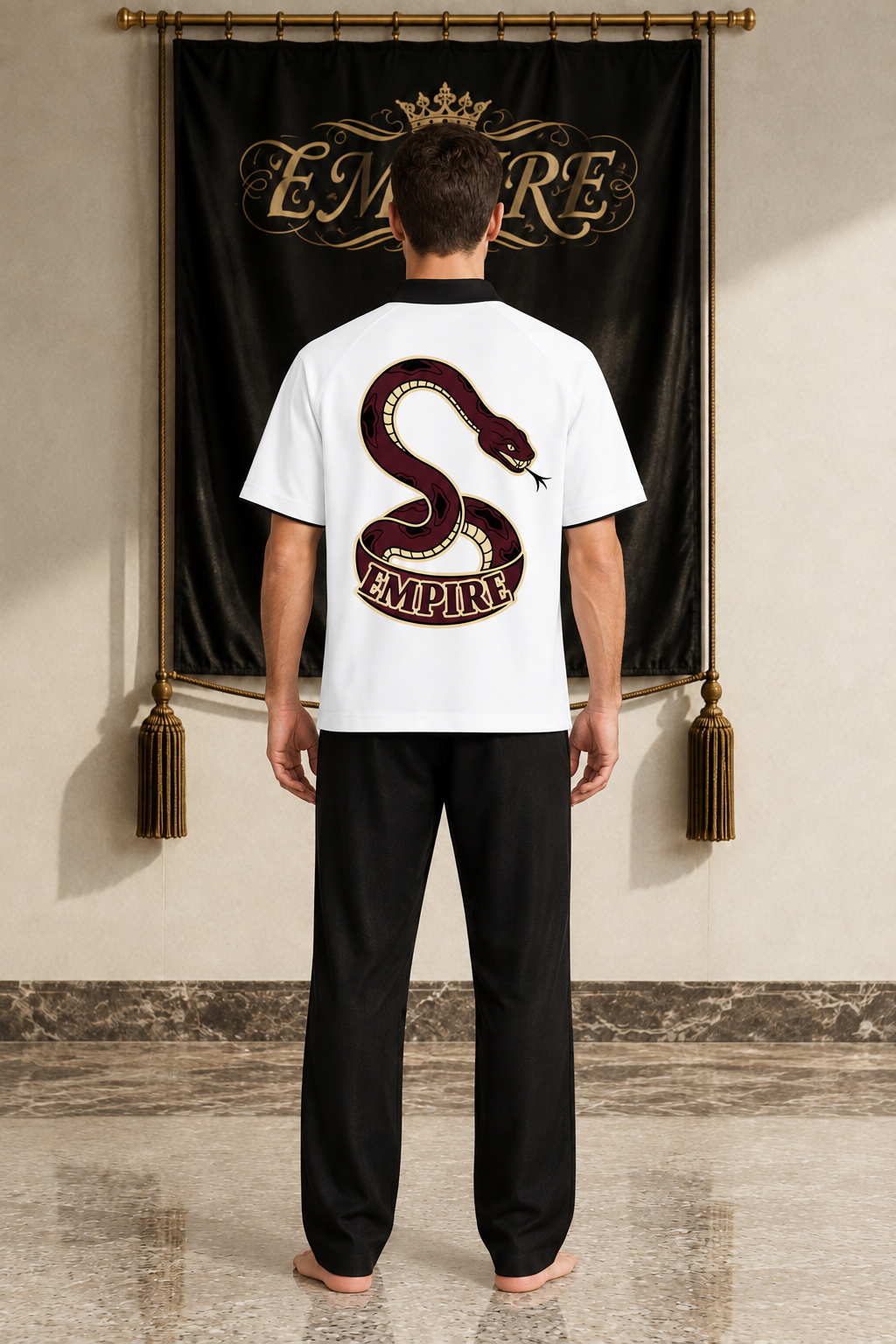White men's EMPIRE raglan polo shirt with black contrast collar and burgundy snake back graphic above the wordmark, rear view on barefoot male model