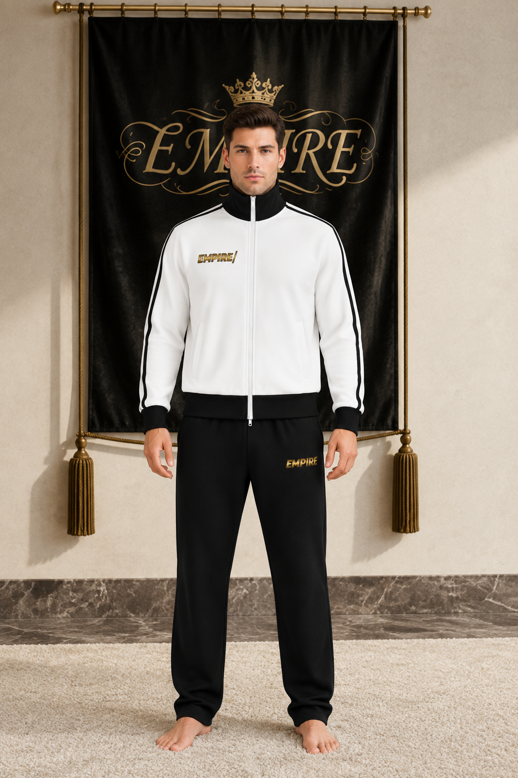 White men's EMPIRE fleece track jacket with black collar, side stripes and gold chest wordmark, front view on barefoot male model