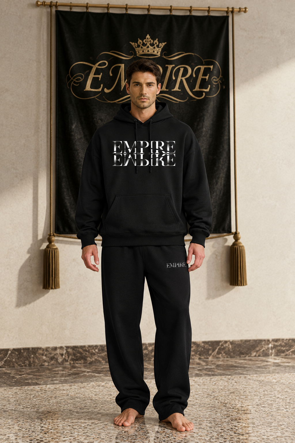 Black men's EMPIRE oversized drop-shoulder hoodie with white mirrored chest wordmark, front view on barefoot male model