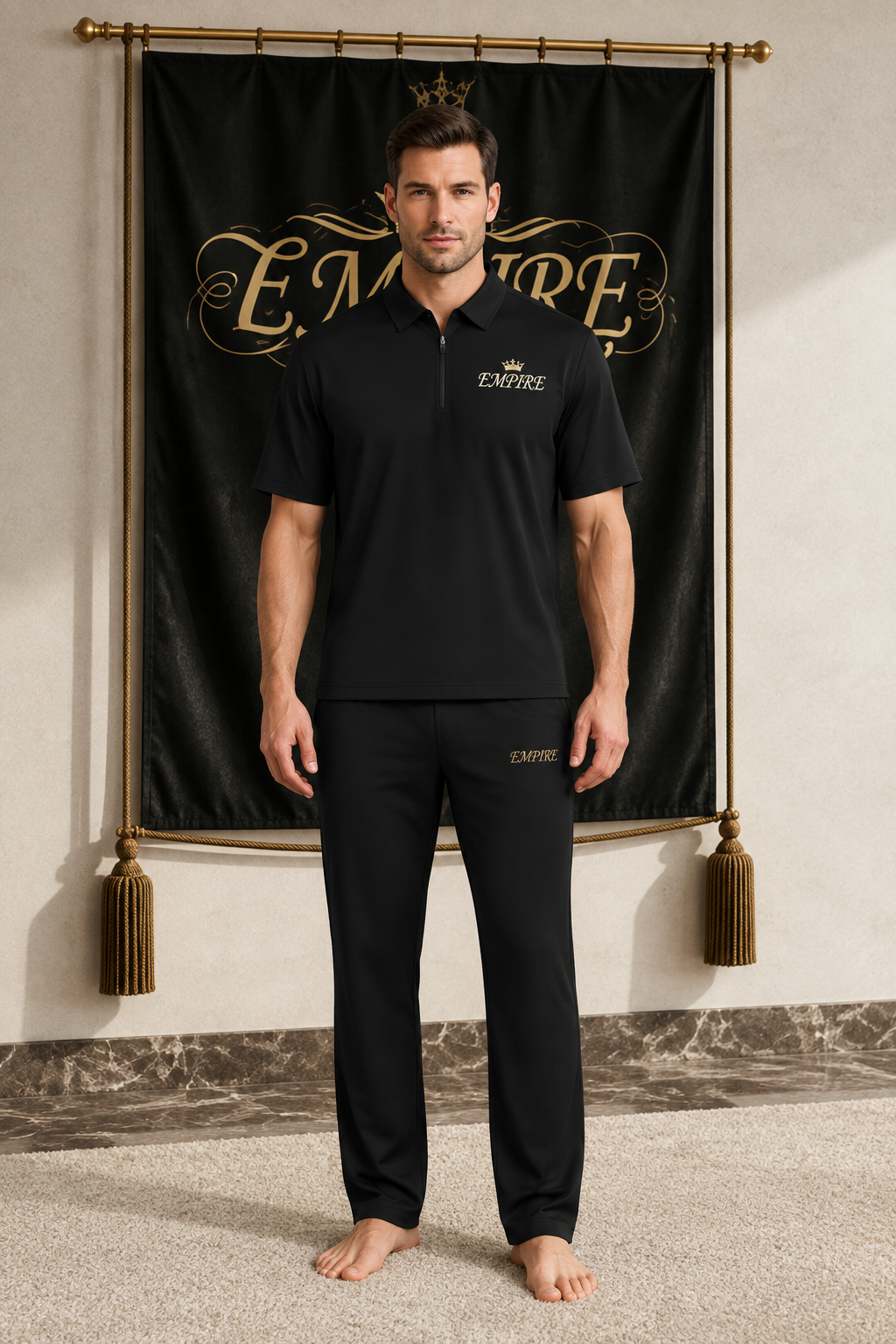 Black men's EMPIRE quarter-zip performance polo with gold crown chest signature, front view on barefoot male model