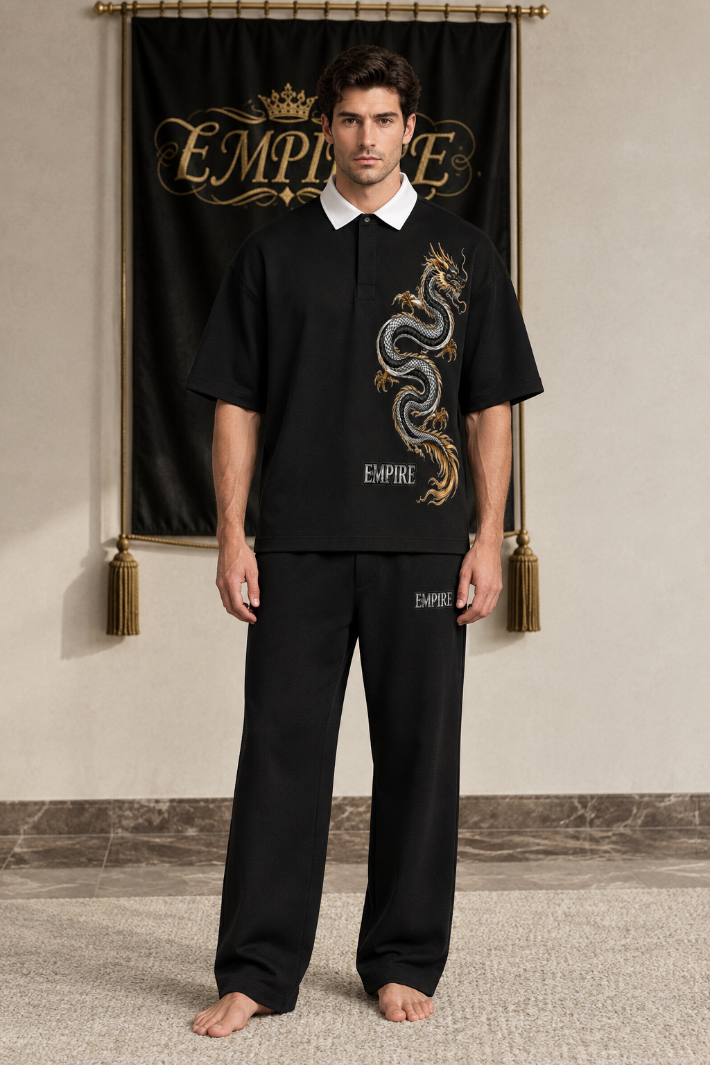 Black men's EMPIRE contrast-collar polo shirt with white collar and vertical silver-and-gold dragon graphic, front view on barefoot male model
