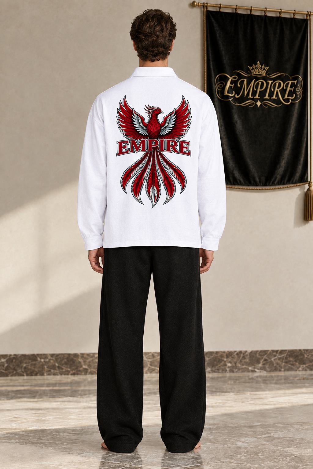 White men's EMPIRE loose long-sleeve polo shirt with spread-wing crimson phoenix and central wordmark, rear view on barefoot male model