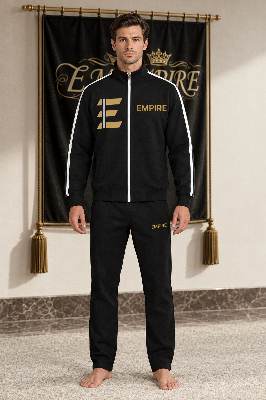 Black men's EMPIRE stand-collar jacket with white side stripes, gold geometric E and gold chest wordmark, front view on barefoot male model