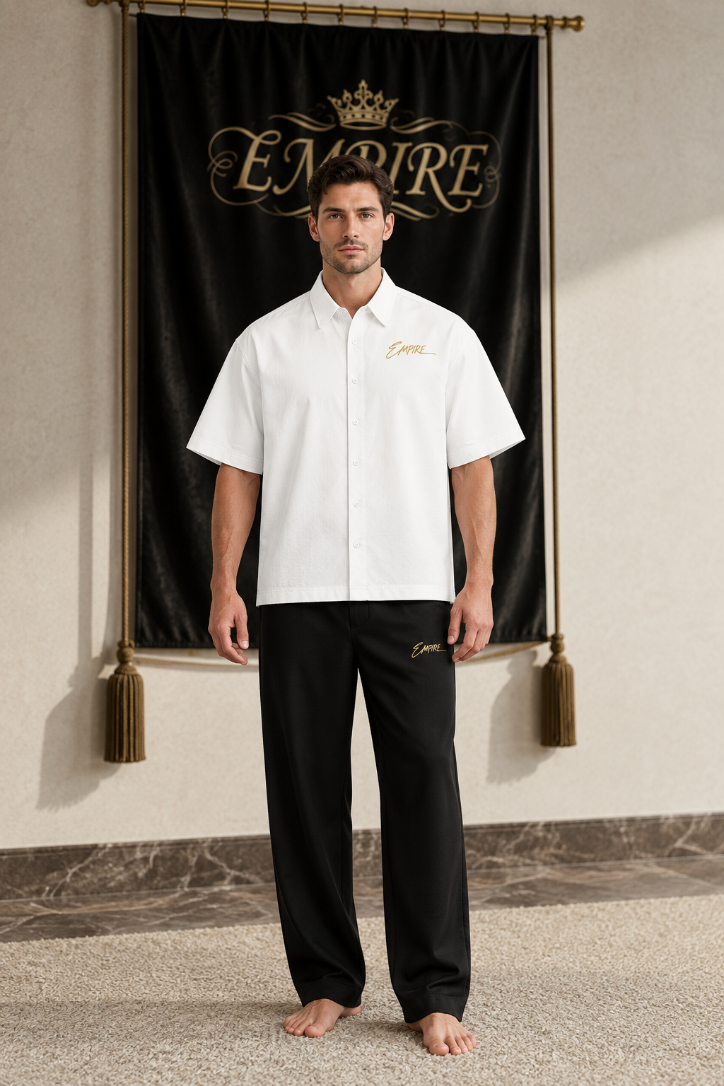 White men's EMPIRE boxy short-sleeve shirt with gold chest signature, front view on barefoot male model